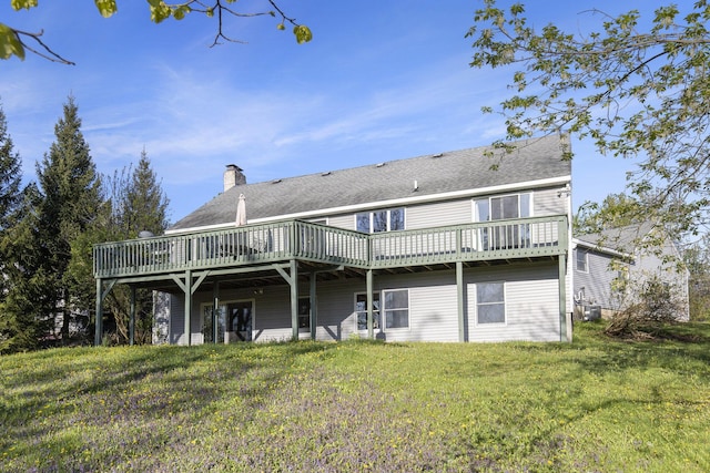 620 Twin Lakes Dr NE, Grand Rapids, MI 49525 - rear view of house featuring a wooden deck, a lawn, a chimney, and cooling unit
