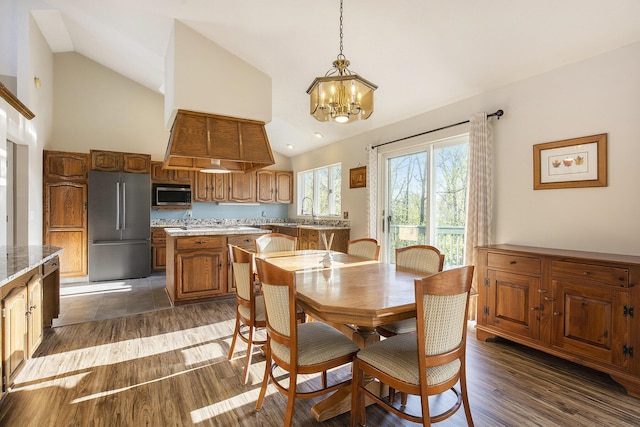 620 Twin Lakes Dr NE, Grand Rapids, MI 49525 - dining space with a chandelier, high vaulted ceiling, and dark wood-style flooring