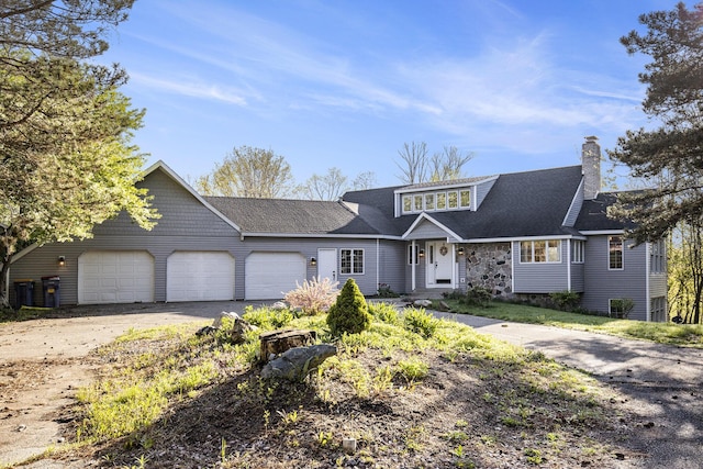 620 Twin Lakes Dr NE, Grand Rapids, MI 49525 - view of front of home featuring an attached garage, asphalt driveway, a chimney, and a shingled roof