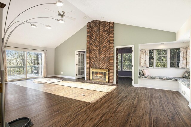 620 Twin Lakes Dr NE, Grand Rapids, MI 49525 - unfurnished living room featuring high vaulted ceiling, a ceiling fan, dark wood-type flooring, baseboards, and a fireplace