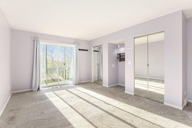 620 Twin Lakes Dr NE, Grand Rapids, MI 49525 - unfurnished bedroom featuring multiple closets, carpet flooring, and baseboards