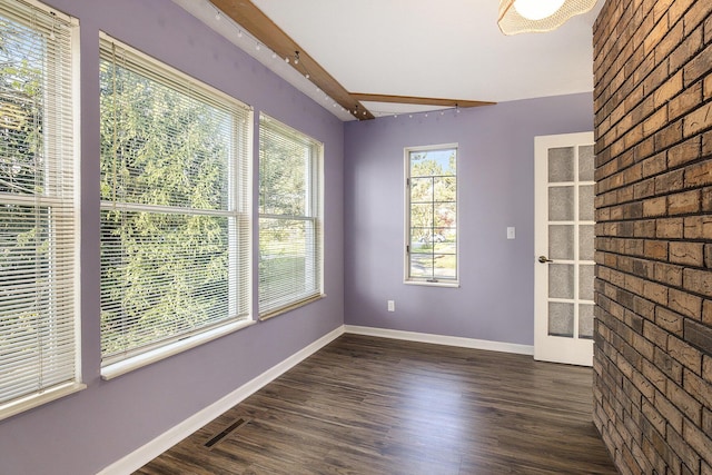 620 Twin Lakes Dr NE, Grand Rapids, MI 49525 - spare room with baseboards, beamed ceiling, and dark wood-type flooring