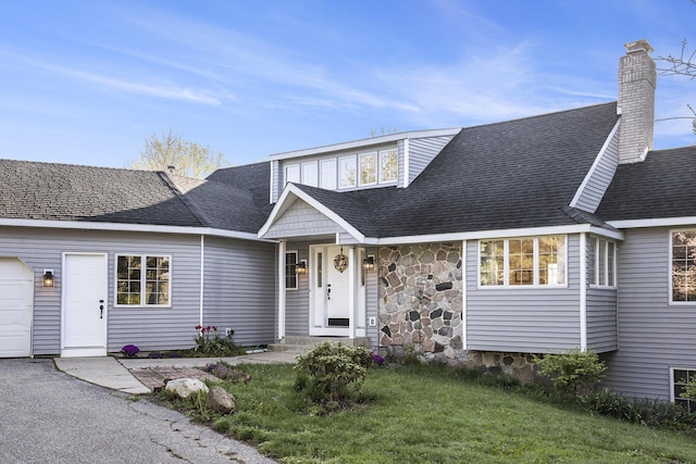 620 Twin Lakes Dr NE, Grand Rapids, MI 49525 - view of front of home featuring stone siding, a chimney, a front lawn, and a shingled roof