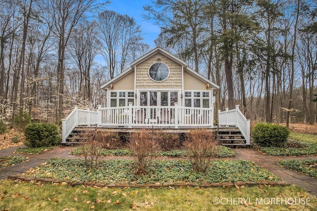 back of property featuring stairway and a deck