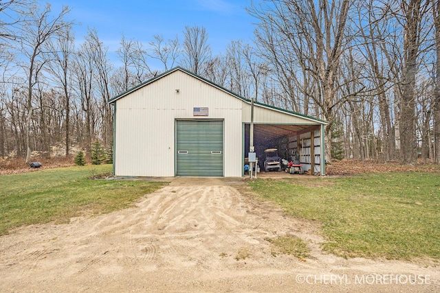 garage with dirt driveway and a garage