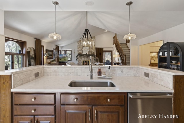 5615 Egypt Valley Ave NE, Belmont, MI 49306 - kitchen featuring stainless steel dishwasher, a sink, open floor plan, a chandelier, and plenty of natural light