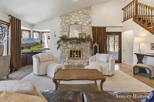5615 Egypt Valley Ave NE, Belmont, MI 49306 - living area with a fireplace, light wood-style floors, plenty of natural light, stairs, and high vaulted ceiling