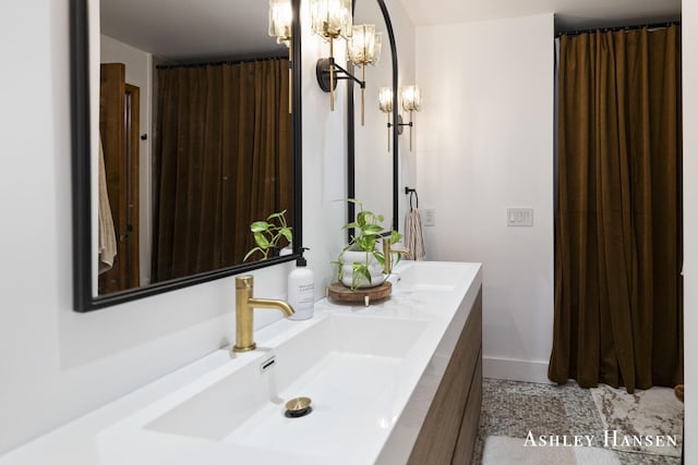 5615 Egypt Valley Ave NE, Belmont, MI 49306 - bathroom featuring double vanity, a chandelier, and baseboards