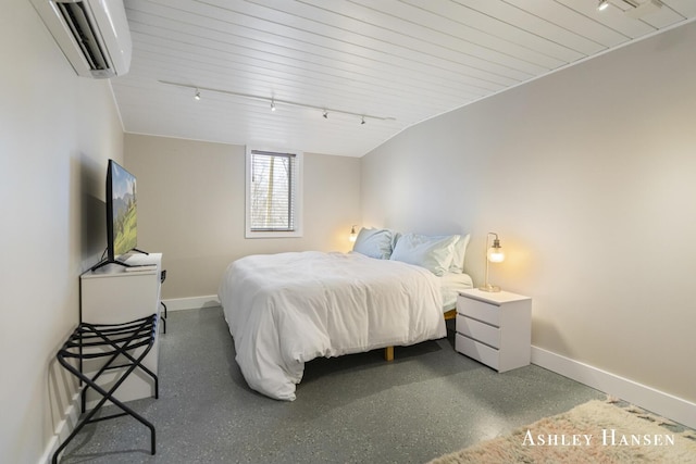 5615 Egypt Valley Ave NE, Belmont, MI 49306 - bedroom featuring an AC wall unit, baseboards, and rail lighting
