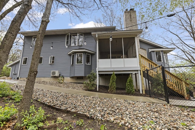 5615 Egypt Valley Ave NE, Belmont, MI 49306 - rear view of property with a chimney, a sunroom, stairway, and a cooling unit
