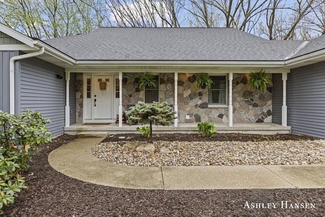 5615 Egypt Valley Ave NE, Belmont, MI 49306 - view of exterior entry with roof with shingles, covered porch, and stone siding