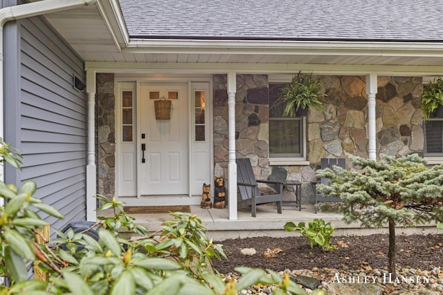 5615 Egypt Valley Ave NE, Belmont, MI 49306 - doorway to property featuring stone siding, roof with shingles, and a porch