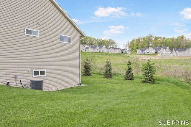 1549 Center Hill Rd SE Unit 37, Lowell, MI 49331 - view of green lawn featuring central AC unit and a residential view