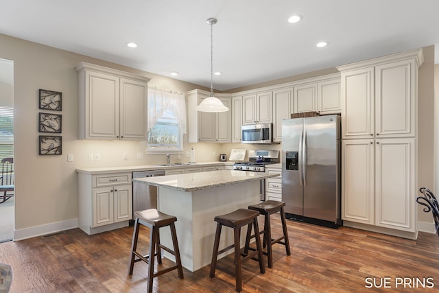 1549 Center Hill Rd SE Unit 37, Lowell, MI 49331 - kitchen featuring appliances with stainless steel finishes, dark wood-style floors, a sink, a kitchen island, and recessed lighting