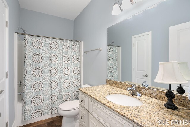 1549 Center Hill Rd SE Unit 37, Lowell, MI 49331 - bathroom with toilet, wood finished floors, vanity, and shower / bathtub combination with curtain