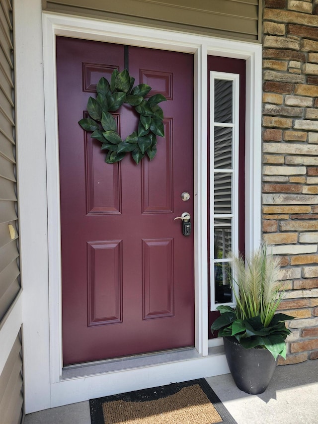 1549 Center Hill Rd SE Unit 37, Lowell, MI 49331 - view of exterior entry featuring stone siding