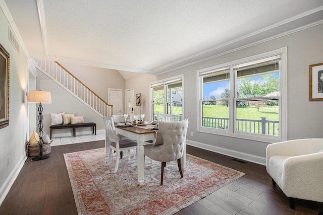 6010 Long Lake Rd, Berrien Springs, MI 49103 - dining space with stairway, dark wood-type flooring, a textured ceiling, and visible vents