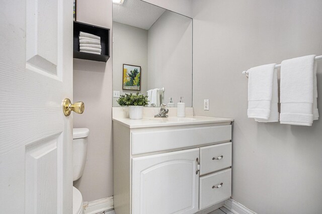6010 Long Lake Rd, Berrien Springs, MI 49103 - half bathroom with baseboards, toilet, and vanity