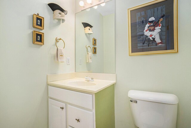 half bathroom with vanity and toilet