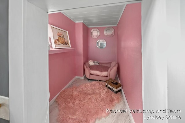 living area featuring baseboards and carpet
