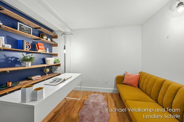 office space with baseboards and light wood-style flooring