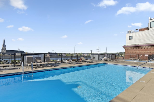 pool with fence and a patio
