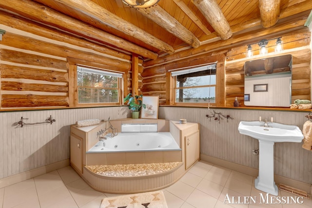 bathroom featuring beam ceiling, a wealth of natural light, wooden ceiling, and a jetted tub