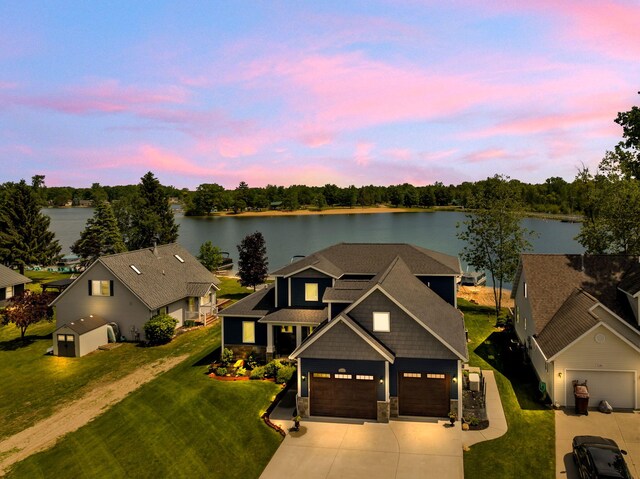 7140 Holiday Dr, Canadian Lakes, MI 49346 - aerial view at dusk featuring a water view