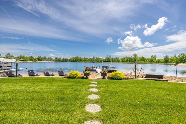 7140 Holiday Dr, Canadian Lakes, MI 49346 - view of yard with a water view, boat lift, and a dock