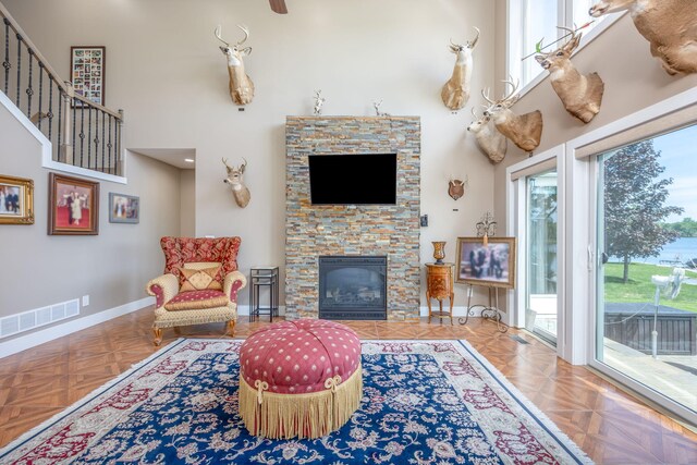 7140 Holiday Dr, Canadian Lakes, MI 49346 - living area with visible vents, a towering ceiling, and a healthy amount of sunlight