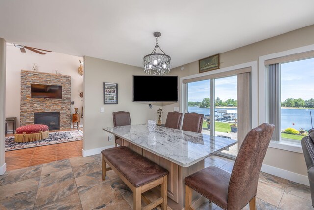 7140 Holiday Dr, Canadian Lakes, MI 49346 - dining area with a fireplace, a notable chandelier, and baseboards