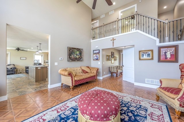 7140 Holiday Dr, Canadian Lakes, MI 49346 - living area with visible vents, baseboards, and ceiling fan