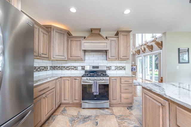 7140 Holiday Dr, Canadian Lakes, MI 49346 - kitchen with appliances with stainless steel finishes, premium range hood, recessed lighting, decorative backsplash, and stone finish flooring