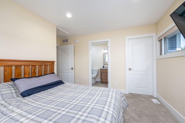 7140 Holiday Dr, Canadian Lakes, MI 49346 - bedroom with visible vents, baseboards, recessed lighting, ensuite bath, and light colored carpet