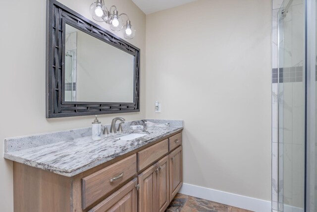 7140 Holiday Dr, Canadian Lakes, MI 49346 - bathroom with baseboards, stone finish floor, vanity, and a shower with door