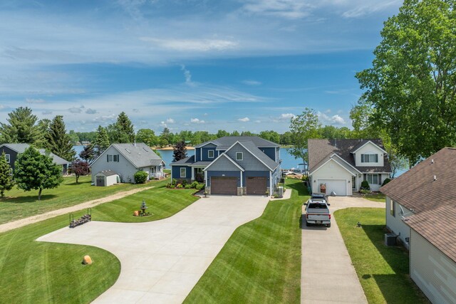7140 Holiday Dr, Canadian Lakes, MI 49346 - view of front of house with cooling unit, concrete driveway, a residential view, and a front lawn