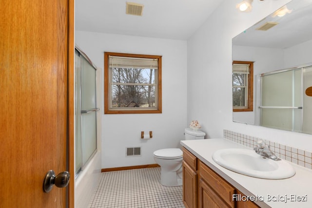 bathroom featuring vanity, baseboards, and visible vents