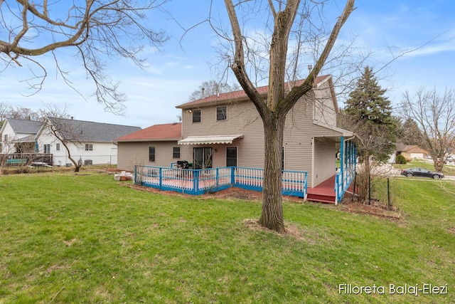 rear view of house featuring a yard