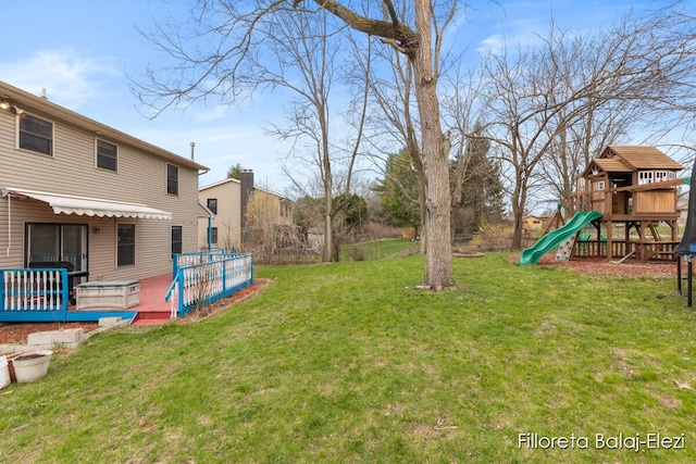 view of yard featuring a deck and a playground