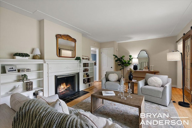 2120 Englewood Dr SE, East Grand Rapids, MI 49506 - living area with a barn door, light wood-style floors, and a fireplace with flush hearth