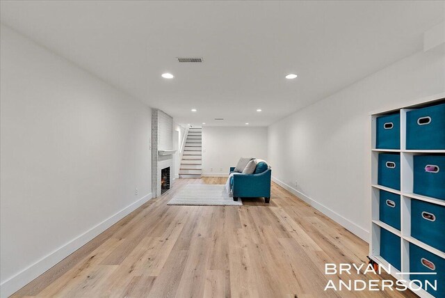 2120 Englewood Dr SE, East Grand Rapids, MI 49506 - unfurnished room featuring wood finished floors, recessed lighting, baseboards, and a brick fireplace