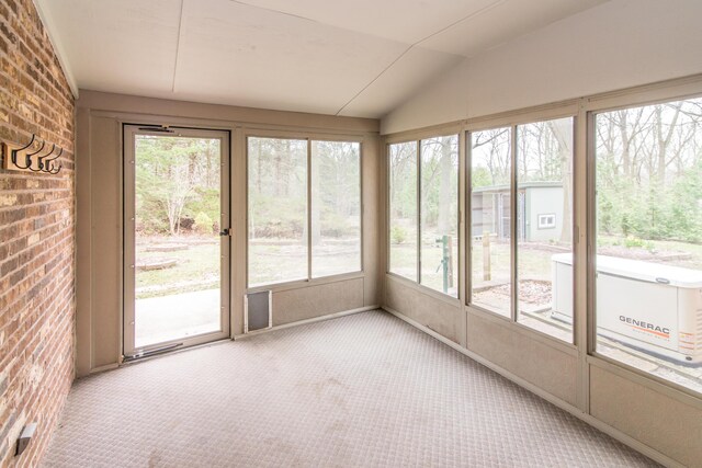 9675 Nabozny Dr, Milan, MI 48160 - unfurnished sunroom featuring brick wall, carpet, and vaulted ceiling