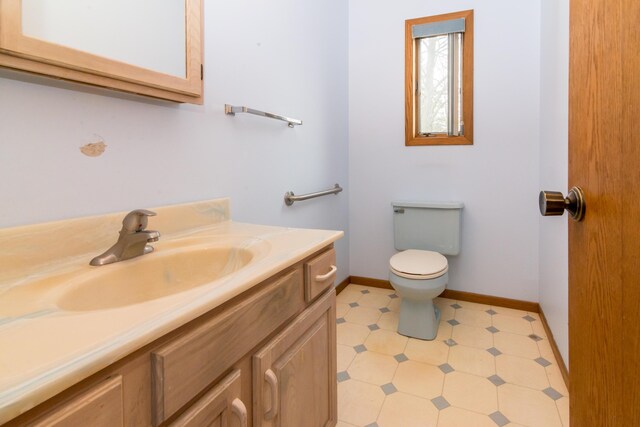 9675 Nabozny Dr, Milan, MI 48160 - half bath with toilet, tile patterned floors, vanity, and baseboards