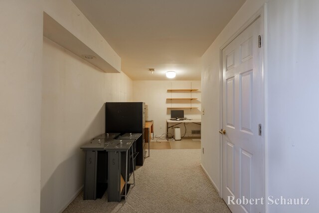 hall with carpet floors and baseboards