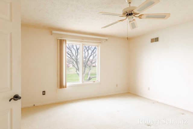 carpeted empty room featuring baseboards, plenty of natural light, and visible vents