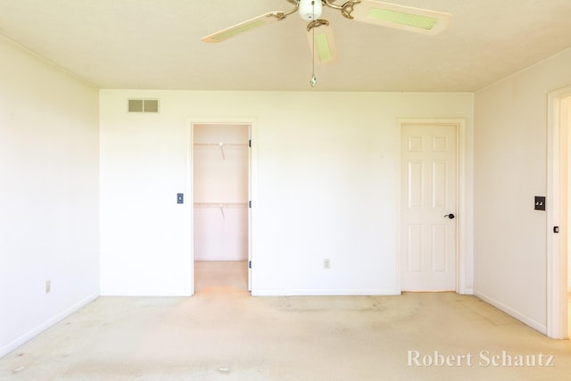 spare room featuring visible vents, a ceiling fan, baseboards, and carpet flooring