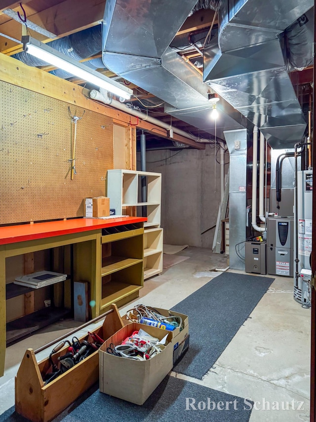 unfinished basement with water heater and a workshop area