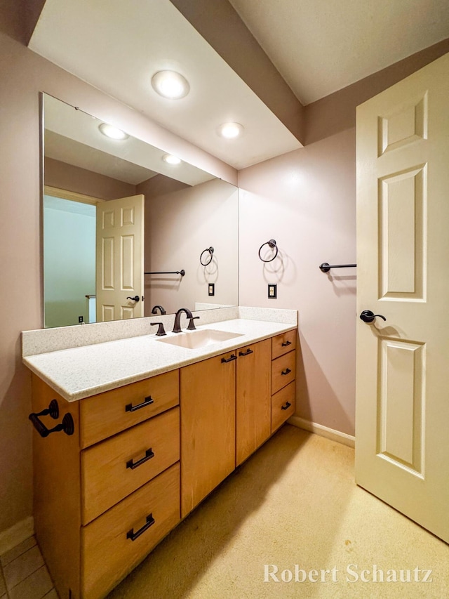 bathroom with recessed lighting, baseboards, and vanity