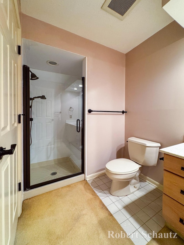 bathroom featuring vanity, toilet, baseboards, a shower stall, and visible vents