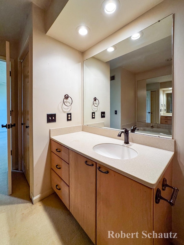 bathroom featuring vanity and recessed lighting